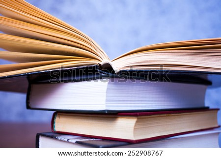 stack of vintage books on blue background