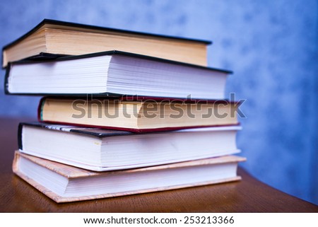 stack of book on the wooden desk of table