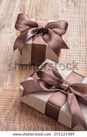 pintage brown paper giftboxes with ribbon on wooden board concept 