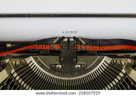 Agency word printed on an old typewriter