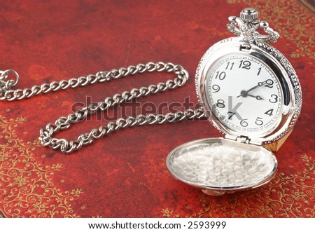 antique silver  pocket watch with ornate relief design