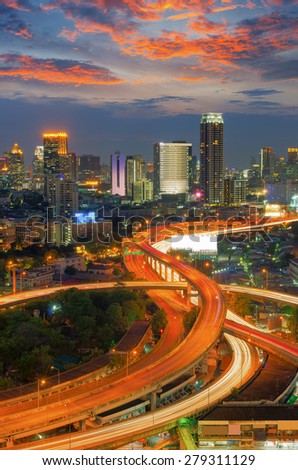 Landscape building modern business district of Bangkok. S-shaped expressway in the foreground at twilight.
