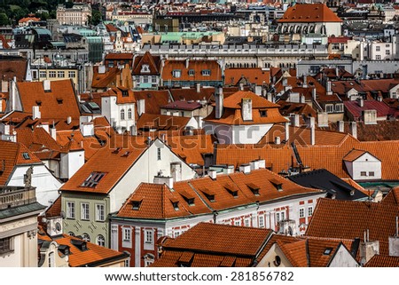 Aerial view: Houses with traditional red roofs in Prague. Prague (Praha) is capital, largest city of Czech Republic and historical capital of Bohemia. Prague situated on Vltava River. 