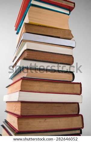 A stack of books over a neutral background