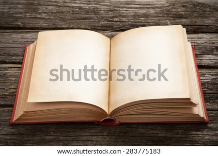 Old open book on wooden background