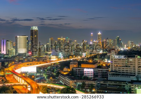 Landscape building modern business district of Bangkok. S-shaped expressway in the foreground at twilight.
