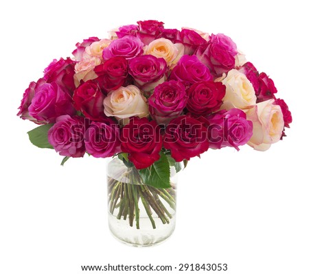 Many roses of red, pink and yellow colors in a vase isolated on white
