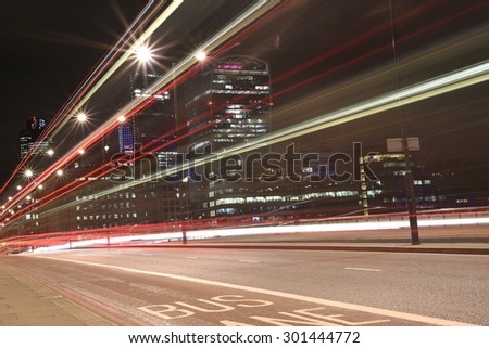Urban city night shot on London Bridge, artistic long exposure shot with light trails of bus lights