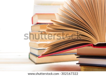 Stack of books on wooden table isolated on white background. Back to school. Copy space