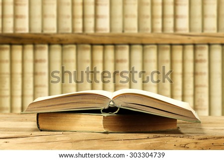 open book on wooden board and books background 