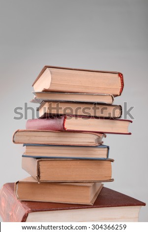 Heap of books on grey background