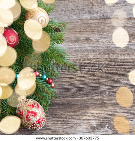 decorated fir tree spruice with bokeh lights on wooden background with copy space