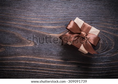 Giftbox on vintage wooden board holiday concept.