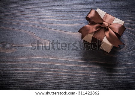 Gift box on vintage wooden board holiday concept.