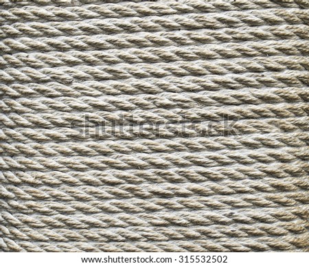 Ecru thick rope wrapped around a pillar closeup
