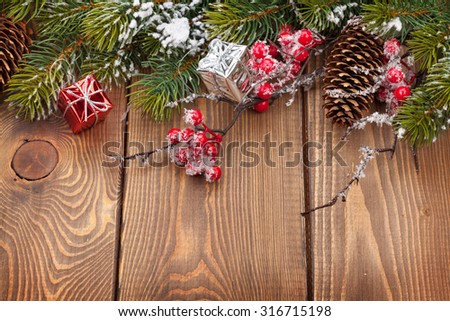Christmas wooden background with snow fir tree and decor with copy space