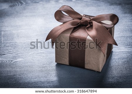 Boxed present on vintage wooden board holiday concept.