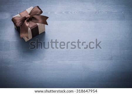 Beaul gift box on vintage wooden board holiday concept.