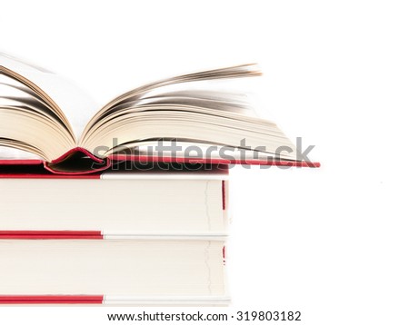 Open book on a stack of books isolated on a white background