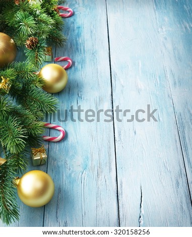 Christmas decoration with fur and baubles on old wood.
