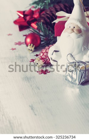 santa claus and christmas toys on a white wooden background. christmas idea. selective focus. copy space for you text. image is tinted