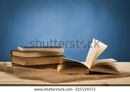A pile of books on blue background