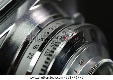 Old lens with rings to set the time, aperture and distance. 