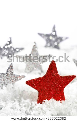 Red Christmas star with silver stars on the snow