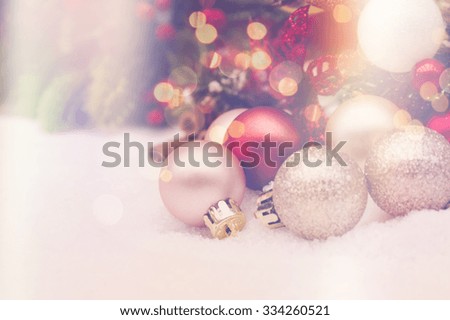 Christmas decorations nestled in snow with retro effect