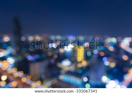 Aerial view of city downtown lights at night, abstract blurred bokeh background