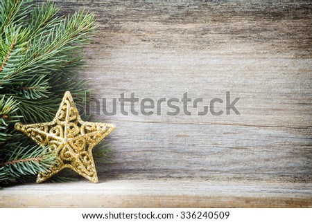 Christmas decoration with fir branches on the wood background.