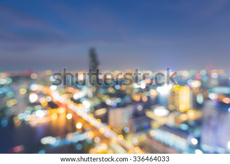 Abstract blurred bokeh lights of city downtown and bridge cross river at night