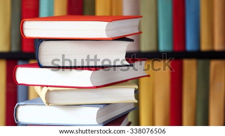 Stacked books and bookshelves; multicolored collection of books