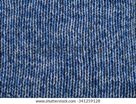Knitted gray and blue wool pattern close up.