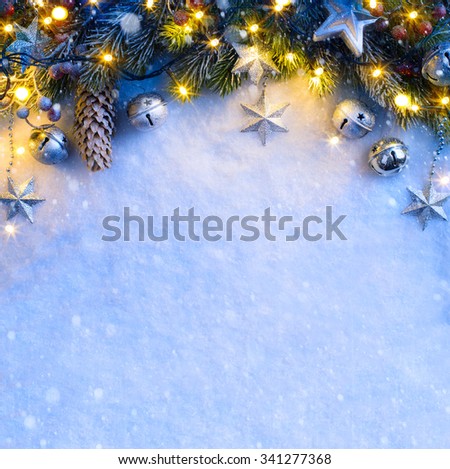 Christmas background with a silver ornament, Christmas stars, berries and fir in snow 