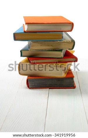 Stack of books on wooden shelf isolated on white background. Back to school. Copy space for text