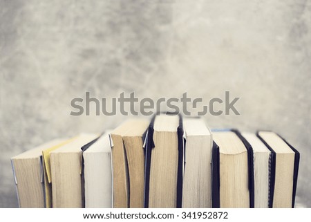 Series of books at concrete wall background