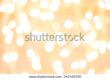 Holiday background with white blurred defocused bokeh. Christmas background. Horizontal. Yellow warm tone