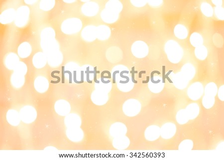 Holiday background with white blurred defocused bokeh. With smal stars. Christmas background. Horizontal. Yellow warm tone