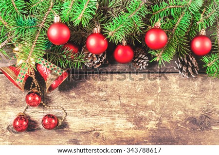 Branches of a Christmas tree on old boards. Christmas background. Christmas decorations. New Year background. Xmax background. Toned image.