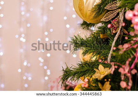 Christmas and New Year Decoration. Bauble on Christmas Tree. Abstract christmas background with defocused lights.