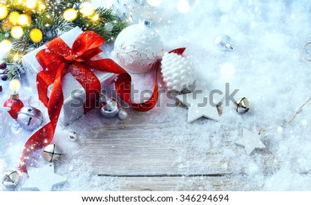 Christmas gift box on snow background and holidays light