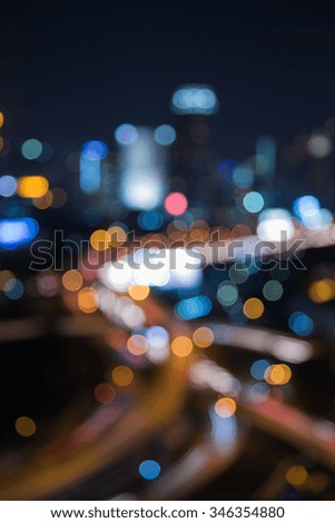 Blurred bokeh light city and interchanged road at night