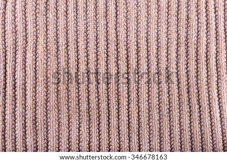 Brown knitted fabric made of heathered yarn textured background