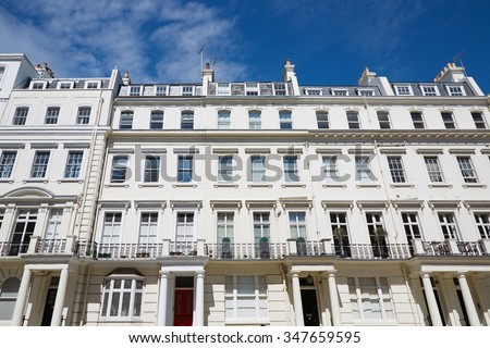 White luxury houses facades in London, english architecture with blue sky