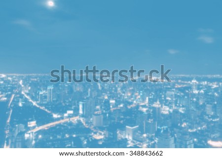 Blurred abstract background of view over cityscape of downtown Bangkok at evening. 
