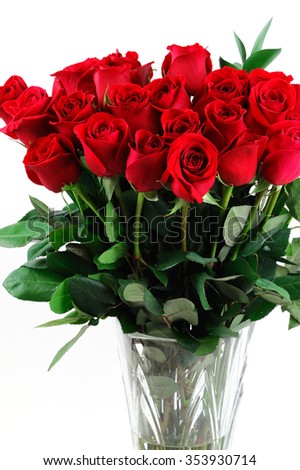 close up on red roses in vase