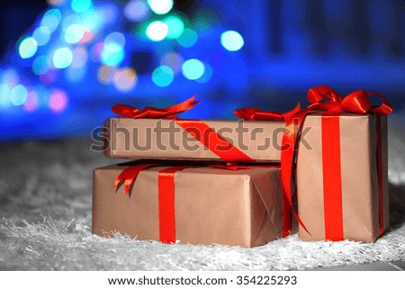 Christmas gift boxes with red ribbon on the floor, close up