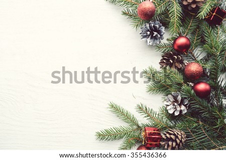 Christmas background with fir branches, pine cones, christmas cookies, cinnamon sticks and anise stars. Top view. Copy space