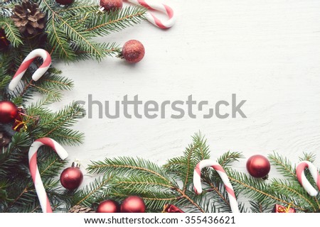Christmas background with fir branches, pine cones, christmas cookies, cinnamon sticks and anise stars. Top view. Copy space
